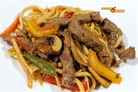 Plato terminado de fideos chinos con ternera, verduras y salsa.