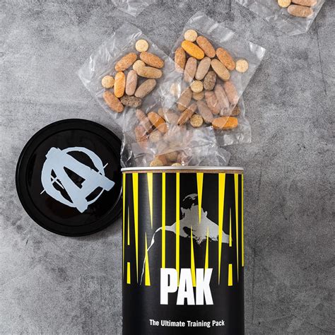 Foto temática de un envase de Animal Pak con píldoras o polvo, en un contexto de gimnasio o entrenamiento.