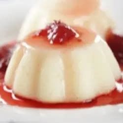 Primer plano de sémola con leche servida en copas individuales con salsa de caramelo y menta