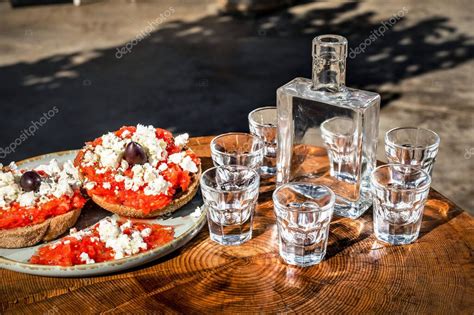 Botella de Raki turco tradicional con vasos de servicio y meze
