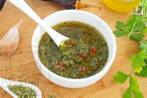 Un bol con la salsa chimichurri mezclada, mostrando la textura y los ingredientes.