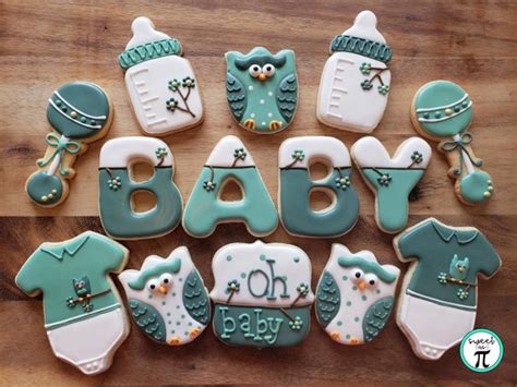 Diseño de conjunto de galletas para baby shower decoradas en tonos rosa pastel y gris plomo con glaseado real.