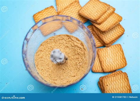 Procesadora moliendo galletas para la base del postre.
