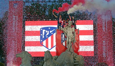 Foto de la fuente de Neptuno con aficionados del Atlético de Madrid celebrando