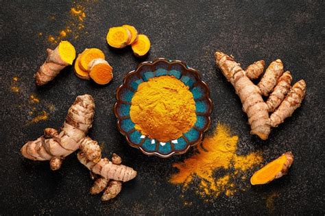 Raíz de cúrcuma fresca junto a trozos de coco.