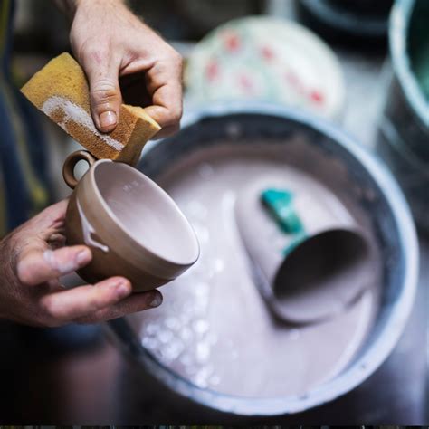 Detalle de una taza decorada con esmalte cerámico de colores vibrantes, mostrando el brillo del acabado vitrificado.
