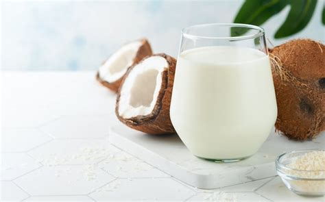 Foto de cocos maduros y leche de coco en un tazón
