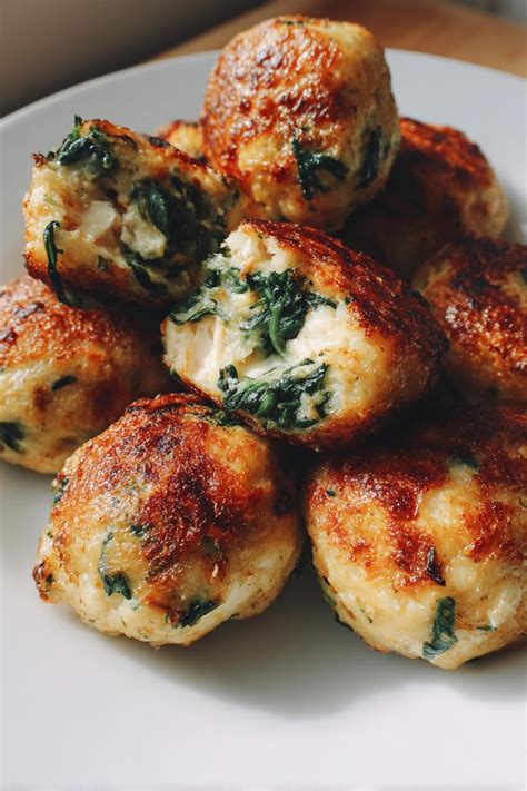 Plato de bolitas de espinaca recién hechas, con un dip o salsa