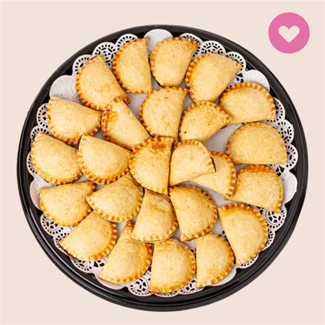 bandeja de mini pastelitos de choclo variados para cóctel con decoración festiva