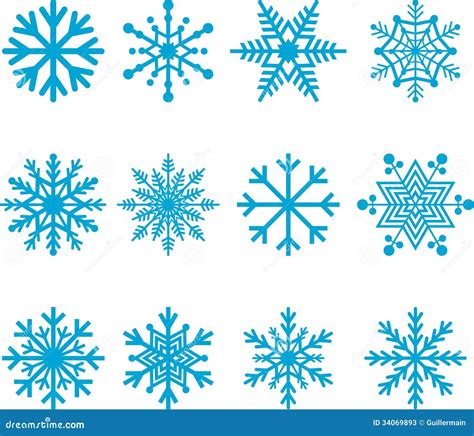 Variedad de galletas decoradas con temática Frozen: copos de nieve azules y blancos, perlas de azúcar y purpurina comestible.