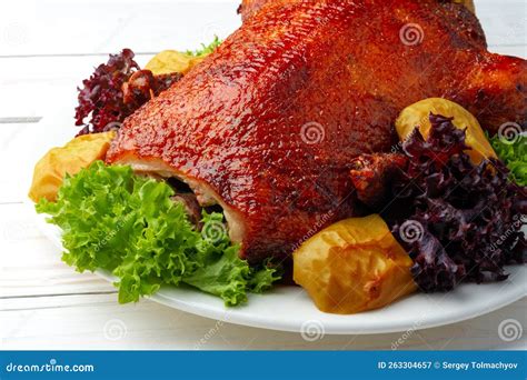 Un ganso entero listo para ser horneado, con hierbas y cítricos