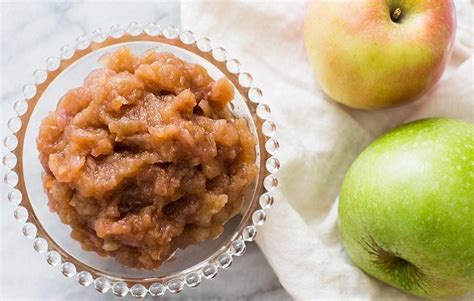 Fotografía de un frasco de chutney de manzana junto a un plato de arroz y carne.