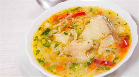 Plato de sopa de arroz con zanahoria y pescado blanco