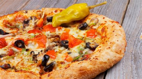 Fotografía gastronómica de una pizza con borde de queso y distintos cortes de pepperoni.