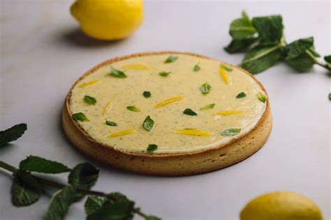 Tarta de limón decorada con hierbas frescas como albahaca, melisa y menta