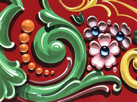 Ilustración de los elementos típicos del fileteado: flores, volutas, cintas y tipografía gótica.