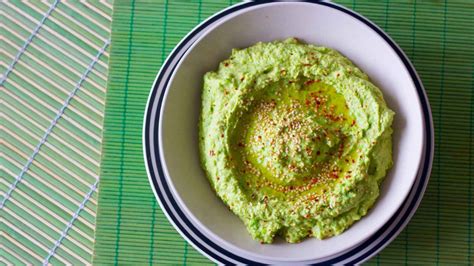 Ingredientes para el hummus de arvejas en una licuadora: arvejas, ajo, limón, aceite de oliva, cilantro.