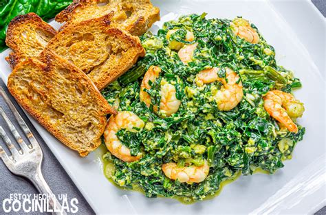 Plato de gambas asadas con tomates, espinacas y gajos de limón.