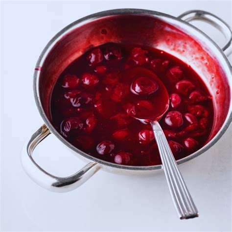 ingredientes frescos para salsa de cerezas incluyendo cerezas rojas, vinagre y azúcar
