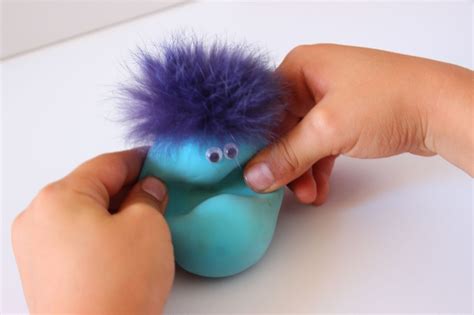 Foto de una pelota antiestrés casera terminada y decorada con ojos y un pequeño detalle que simula cabello
