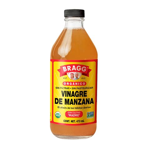 Foto de vinagre de manzana en una botella con manzanas frescas