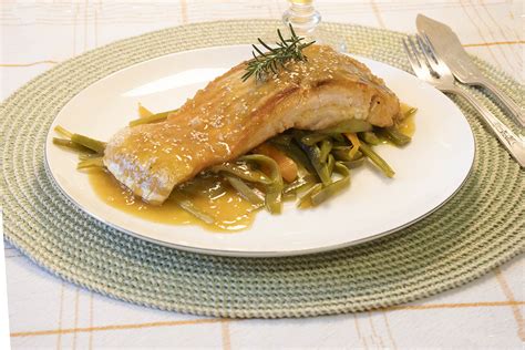 Emplatado artístico de salmón a la naranja con guarnición y decoración.