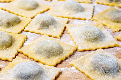 Proceso de emplatado de los raviolis caseros en una superficie con harina.