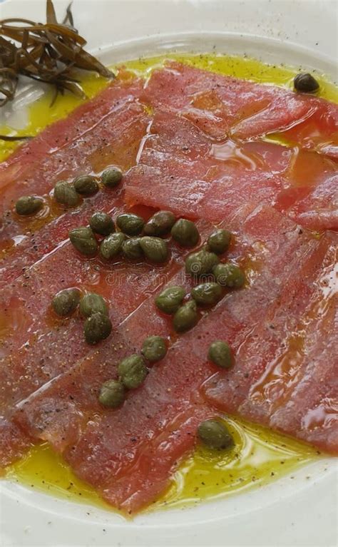 Carpaccio de atún con alcaparras y queso parmesano