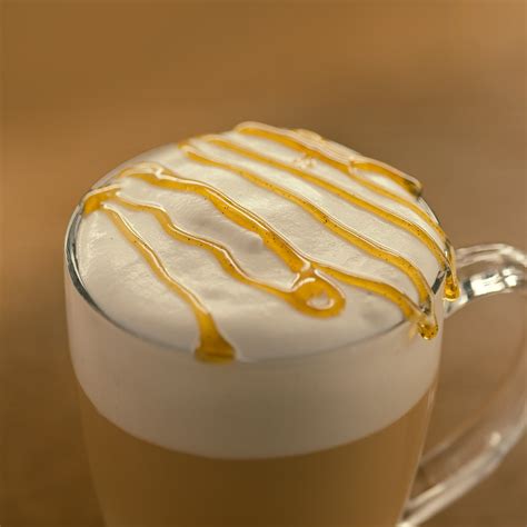 Taza de capuchino de vainilla caliente con arte latte simple y sirope de vainilla