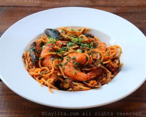 Plato de tallarines con mariscos y camarones en salsa cremosa o roja