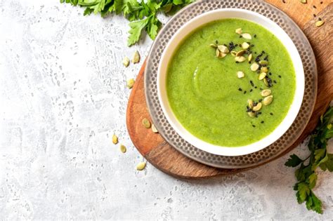 Tazón de crema de verduras vegana humeante con hierbas