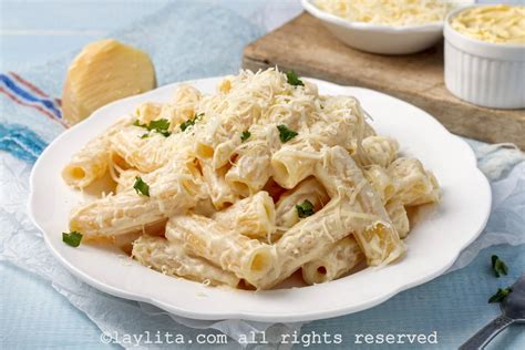 Ingredientes frescos para la salsa Alfredo: mantequilla, crema de leche, queso parmesano y perejil