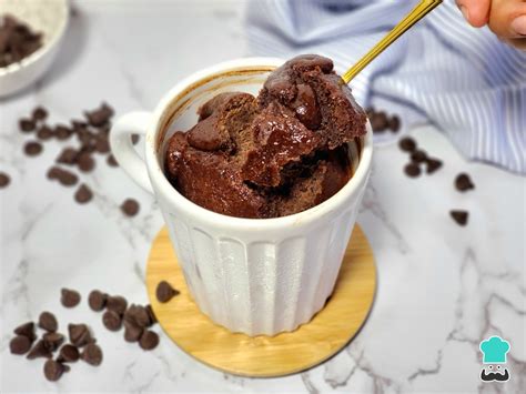 Foto de brownie de chocolate en taza, recién hecho, con una cuchara