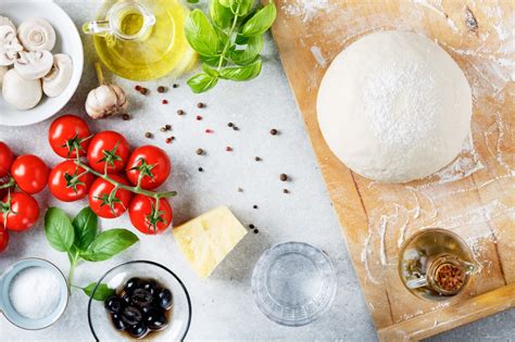 Mesa con ingredientes básicos para masa de pizza y pizzetas