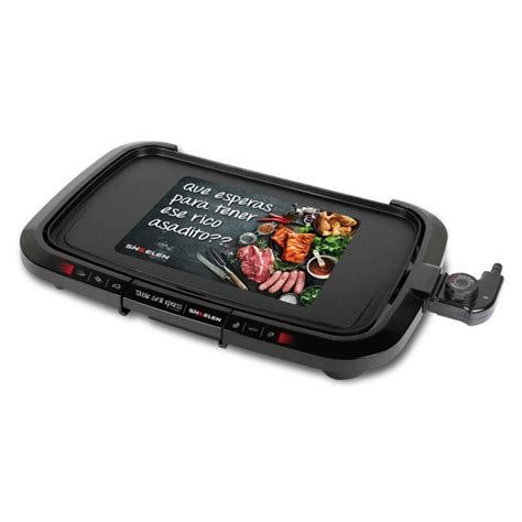 Foto de la parrilla eléctrica Electric Grill Xpress en funcionamiento, mostrando la superficie antiadherente y el depósito de grasas
