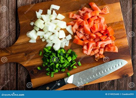 Foto de salchichas frescas y verduras variadas (cebolla, pimiento, calabacín) sobre una tabla de cortar