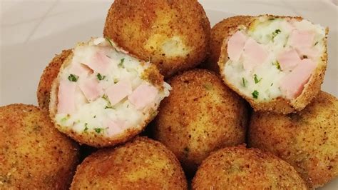 Croquetas de papa recién fritas con una guarnición de ensalada verde