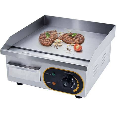 Parrilla eléctrica mostrando sus superficies de cocción y bandeja de grasa