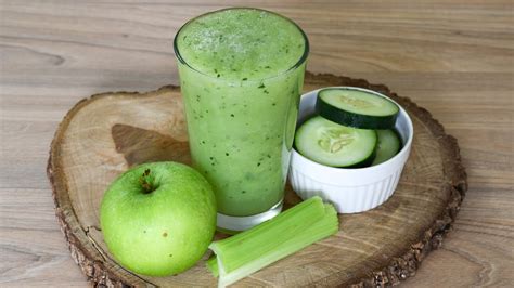 Imagen de los ingredientes para un batido verde, incluyendo espinacas, pepino, manzana y jengibre.