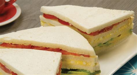 Sándwich triple peruano cortado en triángulos con aceitunas