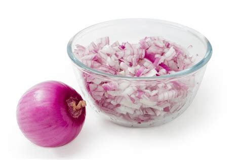 Cebolla morada troceada guardada en un recipiente hermético dentro del refrigerador.