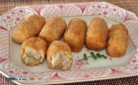 Imagen de croquetas de atún recién hechas, crujientes y doradas, con un relleno de queso visible