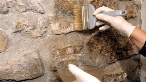 Proceso de limpieza de una piedra para pizza con espátula y cepillo