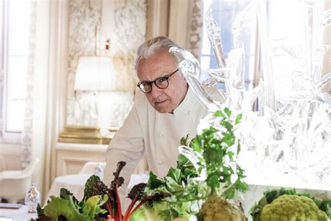 Retrato de Alain Ducasse, chef francés, con sus libros y colecciones de utensilios de cocina
