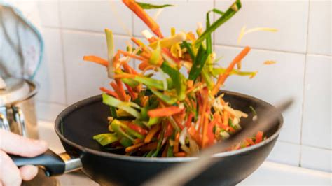 Diferencia entre un wok y una sartén, destacando el calor intenso