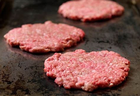 hamburguesa smash burger cocinándose en plancha