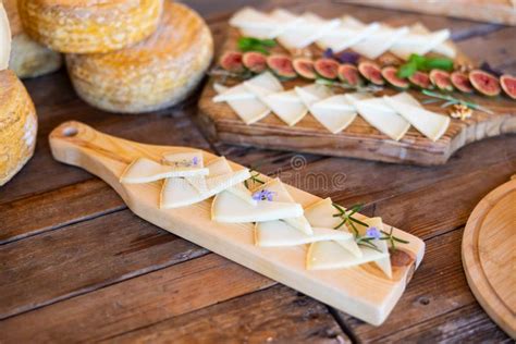 Rueda de queso provolone y lonchas en tabla de madera