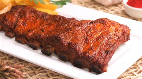 Fotografía de un costillar de cerdo dorado y jugoso recién salido del horno.