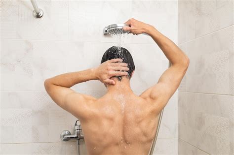Persona tomando una ducha fría después de entrenar, con sensación de energía y alerta.