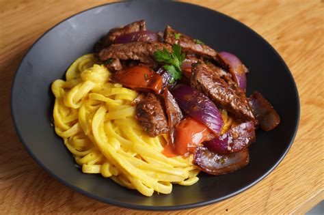plato de tallarines a la huancaína con lomo saltado y queso parmesano